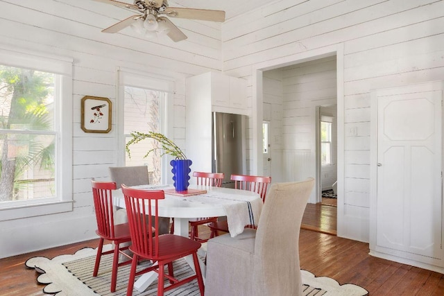 1211 E 13th St, Austin, TX 78702 - dining room with wood walls, ceiling fan, and hardwood / wood-style floors