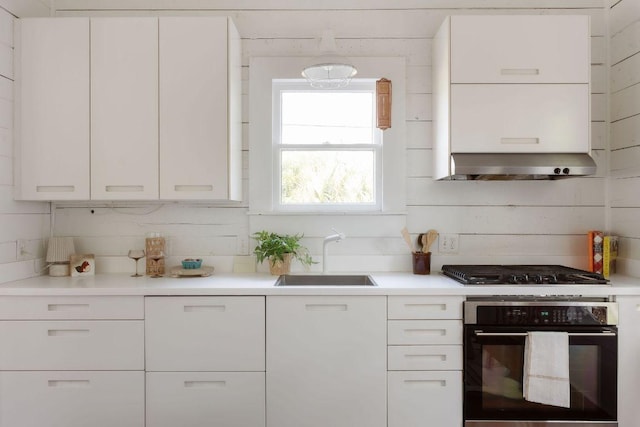 1211 E 13th St, Austin, TX 78702 - kitchen featuring black oven, a sink, extractor fan, and white cabinets