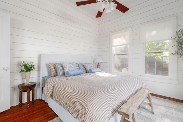 1211 E 13th St, Austin, TX 78702 - bedroom with wood walls, baseboards, wood finished floors, and a ceiling fan