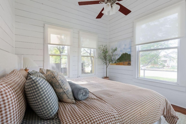 1211 E 13th St, Austin, TX 78702 - bedroom featuring wood finished floors, wooden walls, and a ceiling fan