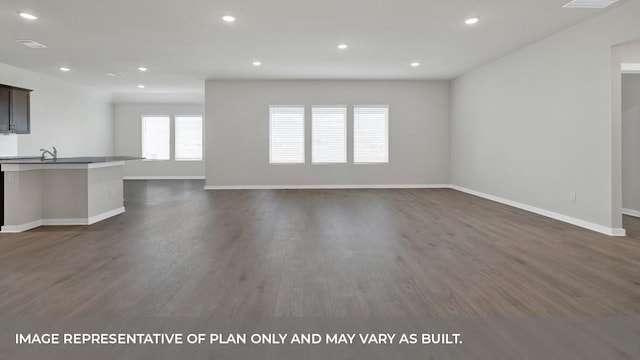 362 Barron Estate Dr, Lockhart, TX 78644 - unfurnished living room featuring dark wood-type flooring, baseboards, and recessed lighting
