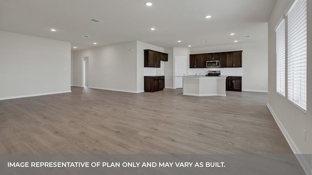 362 Barron Estate Dr, Lockhart, TX 78644 - unfurnished living room featuring light wood finished floors, recessed lighting, and baseboards