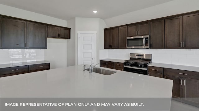 362 Barron Estate Dr, Lockhart, TX 78644 - kitchen with appliances with stainless steel finishes, a sink, dark brown cabinets, tasteful backsplash, and recessed lighting