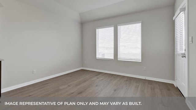 362 Barron Estate Dr, Lockhart, TX 78644 - unfurnished bedroom with wood finished floors, baseboards, and lofted ceiling