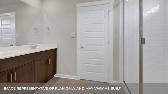 362 Barron Estate Dr, Lockhart, TX 78644 - full bath featuring double vanity, a shower stall, baseboards, and wood finished floors