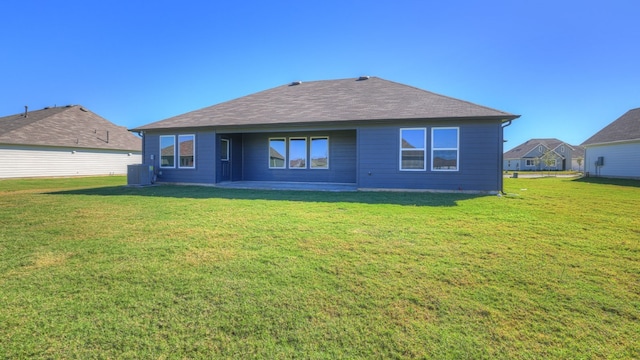 362 Barron Estate Dr, Lockhart, TX 78644 - rear view of property featuring central AC, a yard, and roof with shingles