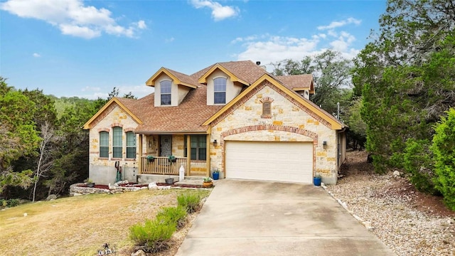 1454 Rose Ln, Canyon Lake, TX 78133 - french country home featuring stone siding, covered porch, driveway, a garage, and roof with shingles