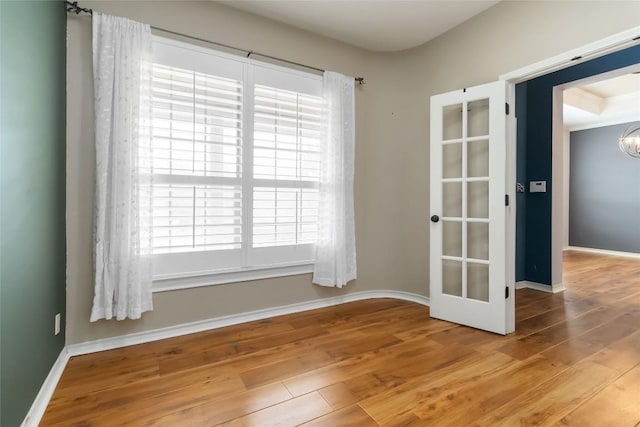 1454 Rose Ln, Canyon Lake, TX 78133 - spare room featuring wood finished floors, baseboards, and a chandelier