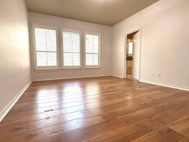1454 Rose Ln, Canyon Lake, TX 78133 - spare room featuring baseboards and hardwood / wood-style flooring