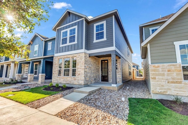 1621 Coral Sunrise Aly, Leander, TX 78641 - view of front of house featuring board and batten siding, stone siding, and covered porch