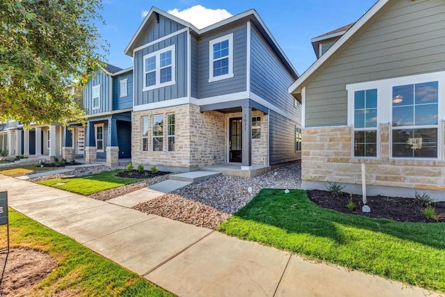 1621 Coral Sunrise Aly, Leander, TX 78641 - view of front facade featuring board and batten siding and stone siding