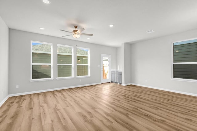 1621 Coral Sunrise Aly, Leander, TX 78641 - unfurnished living room featuring ceiling fan, light wood-style flooring, baseboards, and recessed lighting