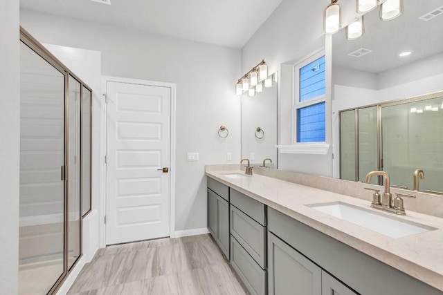 1621 Coral Sunrise Aly, Leander, TX 78641 - full bathroom featuring double vanity, a shower stall, and baseboards