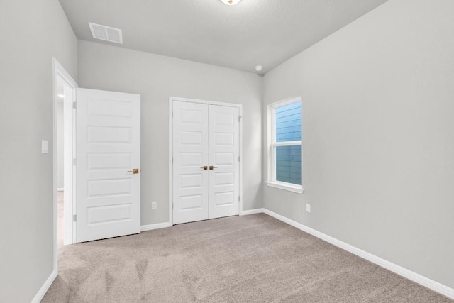 1621 Coral Sunrise Aly, Leander, TX 78641 - unfurnished bedroom featuring carpet floors, a closet, and baseboards