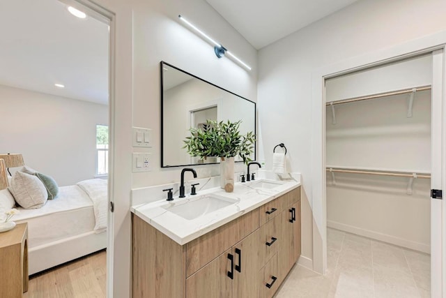 1314 Ridgemont Dr, Austin, TX 78723 - full bathroom with double vanity, a spacious closet, baseboards, and recessed lighting