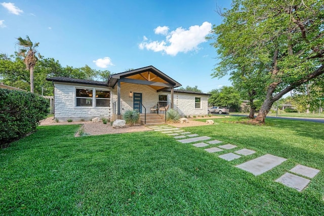 1314 Ridgemont Dr, Austin, TX 78723 - ranch-style home with stone siding, a front yard, and a porch
