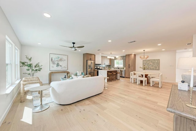 1314 Ridgemont Dr, Austin, TX 78723 - living room featuring a chandelier, light wood finished floors, recessed lighting, and a ceiling fan