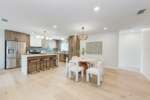 1314 Ridgemont Dr, Austin, TX 78723 - dining room with a chandelier, light wood-style flooring, recessed lighting, and baseboards