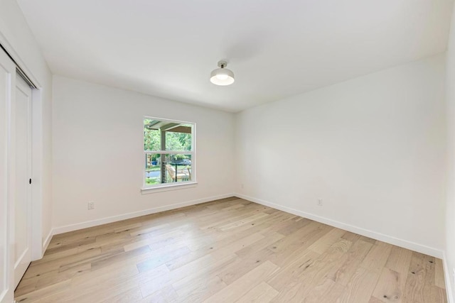 1314 Ridgemont Dr, Austin, TX 78723 - unfurnished bedroom with light wood-style floors, a closet, and baseboards