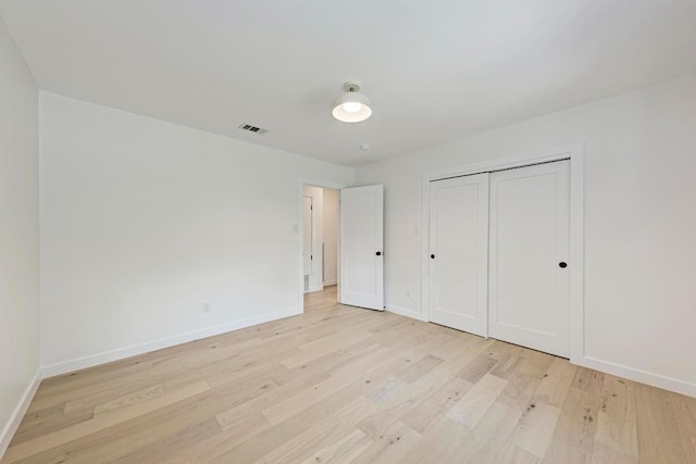 1314 Ridgemont Dr, Austin, TX 78723 - unfurnished bedroom featuring light wood-type flooring, baseboards, and a closet