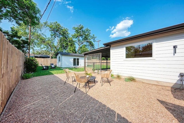 1314 Ridgemont Dr, Austin, TX 78723 - fenced backyard featuring an outdoor structure and a patio