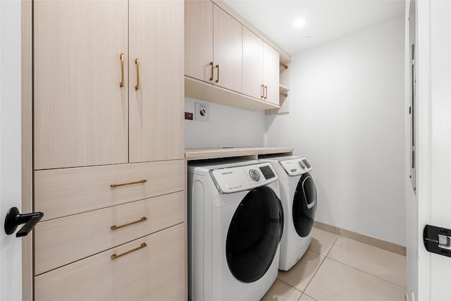 70 Rainey St Unit 2106, Austin, TX 78701 - washroom with cabinet space, washing machine and clothes dryer, and light tile patterned floors