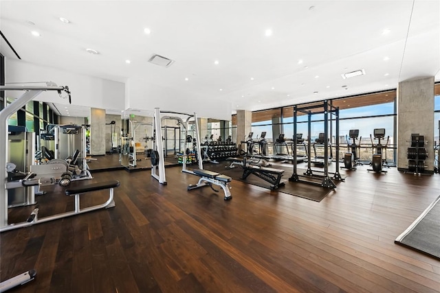 70 Rainey St Unit 2106, Austin, TX 78701 - exercise room featuring floor to ceiling windows, wood finished floors, and recessed lighting