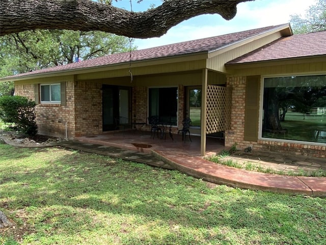 140 Oakridge Rd, Georgetown, TX 78628 - rear view of house with brick siding, roof with shingles, and a patio