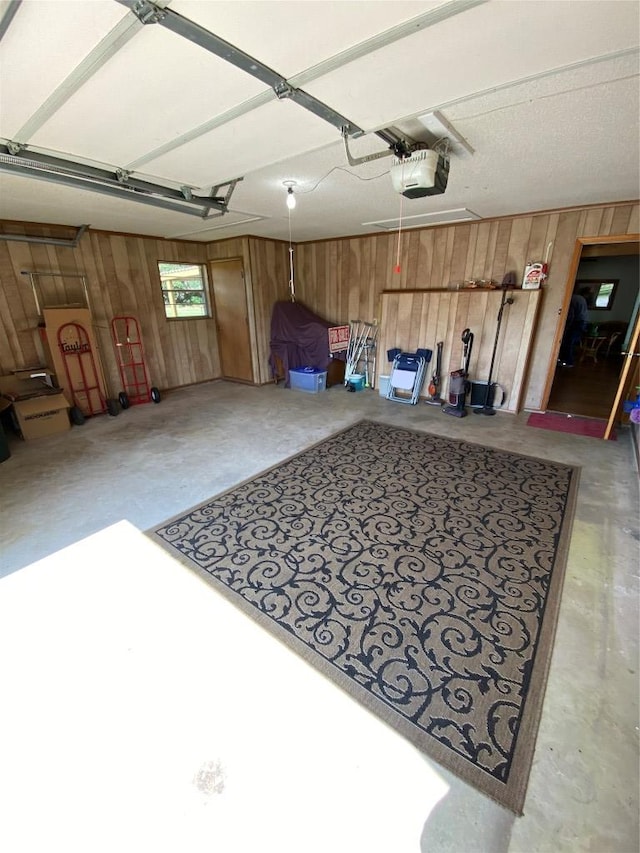140 Oakridge Rd, Georgetown, TX 78628 - garage featuring wooden walls and a garage door opener