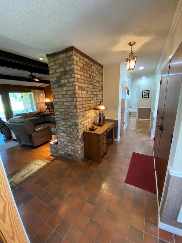 140 Oakridge Rd, Georgetown, TX 78628 - hall featuring a textured ceiling, tile patterned floors, a chandelier, ornamental molding, and baseboards