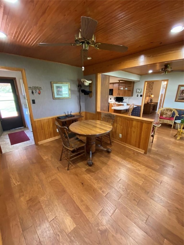 140 Oakridge Rd, Georgetown, TX 78628 - dining space with wooden ceiling, wood-type flooring, a ceiling fan, a wainscoted wall, and wood walls