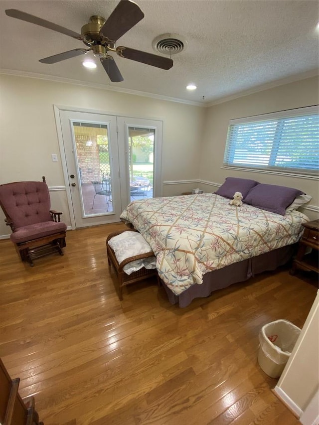 140 Oakridge Rd, Georgetown, TX 78628 - bedroom featuring access to exterior, light wood-style flooring, ornamental molding, a textured ceiling, and ceiling fan