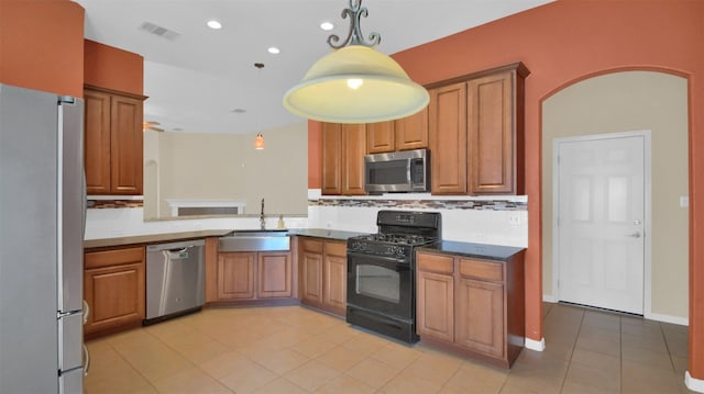 18409 Hees Ln, Pflugerville, TX 78660 - kitchen with appliances with stainless steel finishes, a sink, light tile patterned flooring, hanging light fixtures, and recessed lighting