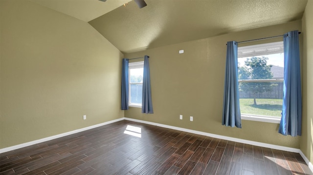 18409 Hees Ln, Pflugerville, TX 78660 - empty room featuring baseboards, dark wood-type flooring, vaulted ceiling, a textured ceiling, and ceiling fan