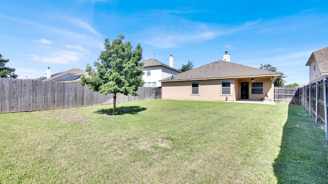 18409 Hees Ln, Pflugerville, TX 78660 - rear view of house featuring ceiling fan, a patio, a chimney, stucco siding, and roof with shingles