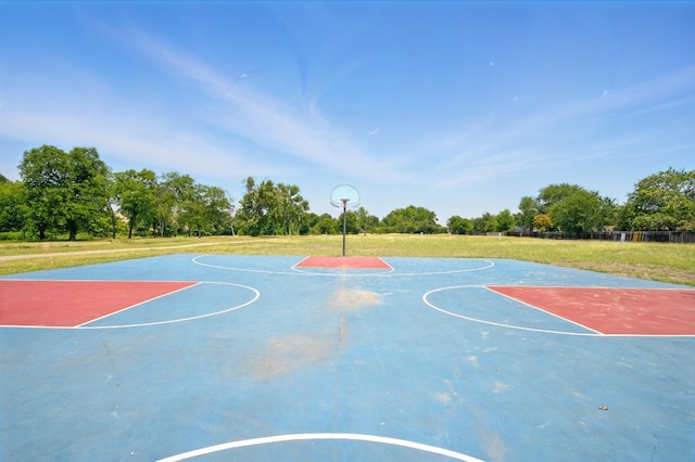 179 Pimlico, Kyle, TX 78640 - view of sport court featuring community basketball court, a yard, and view of wooded area