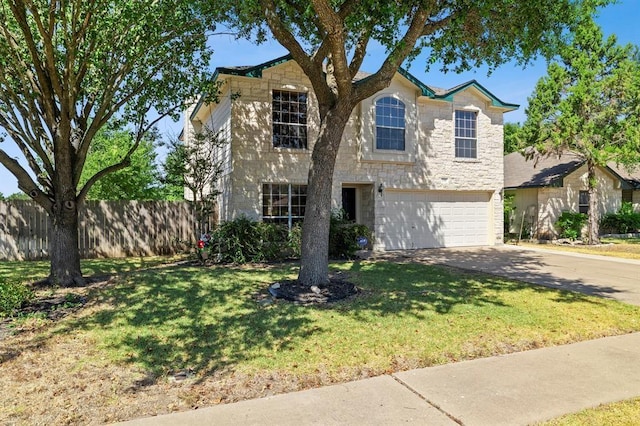 2511 Jacqueline Dr, Leander, TX 78641 - traditional home with stone siding, concrete driveway, and an attached garage