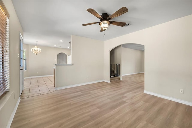 2511 Jacqueline Dr, Leander, TX 78641 - unfurnished living room with arched walkways, light wood-style flooring, a ceiling fan, recessed lighting, and baseboards