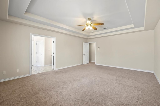 2511 Jacqueline Dr, Leander, TX 78641 - unfurnished room with a tray ceiling, light colored carpet, a ceiling fan, and baseboards