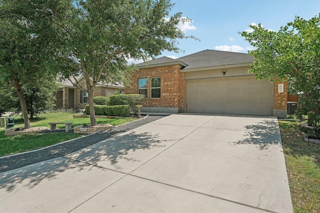 432 Druse Ln, Jarrell, TX 76537 - view of front facade featuring concrete driveway, a garage, brick siding, and a front lawn