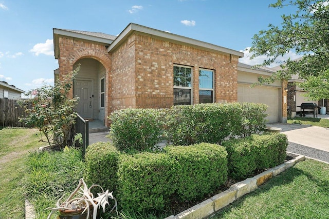 432 Druse Ln, Jarrell, TX 76537 - view of front of house featuring brick siding, an attached garage, and driveway