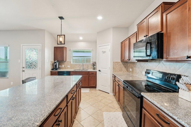 432 Druse Ln, Jarrell, TX 76537 - kitchen featuring black appliances, a sink, brown cabinetry, hanging light fixtures, and recessed lighting