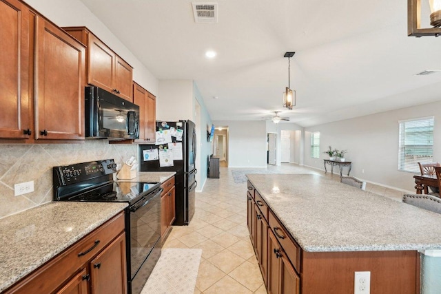 432 Druse Ln, Jarrell, TX 76537 - kitchen featuring black appliances, ceiling fan, brown cabinetry, tasteful backsplash, and plenty of natural light