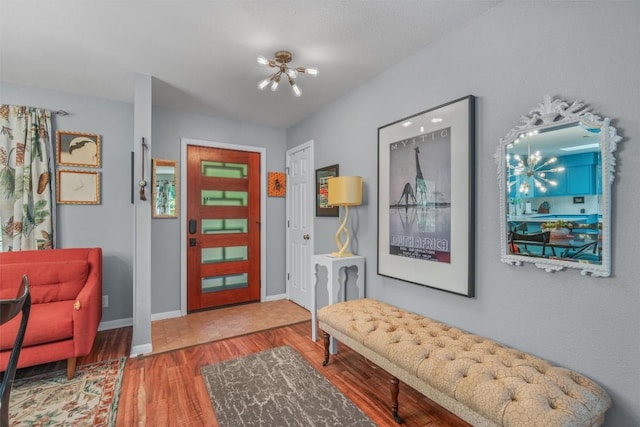 259 Akaloa Dr, Bastrop, TX 78602 - entryway featuring wood finished floors, a chandelier, and baseboards