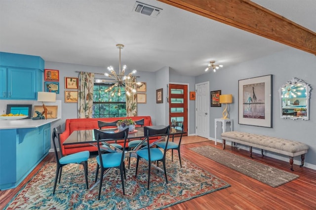 259 Akaloa Dr, Bastrop, TX 78602 - dining space featuring a chandelier, baseboards, and wood finished floors