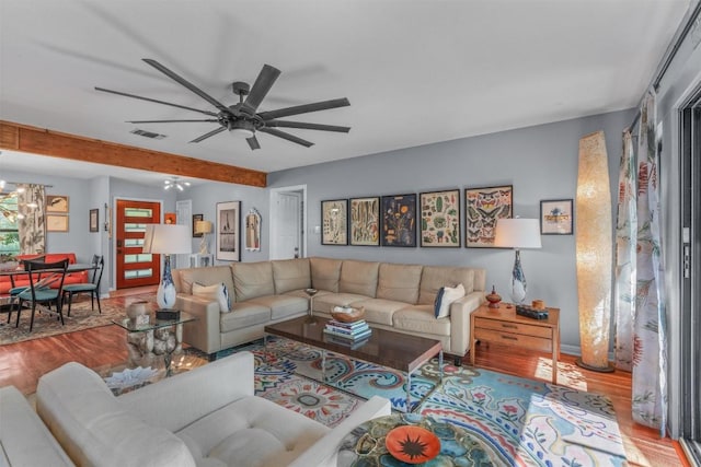 259 Akaloa Dr, Bastrop, TX 78602 - living area featuring wood finished floors, ceiling fan, and beamed ceiling