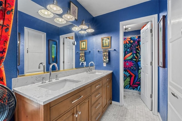 259 Akaloa Dr, Bastrop, TX 78602 - bathroom featuring double vanity, tile patterned floors, and baseboards
