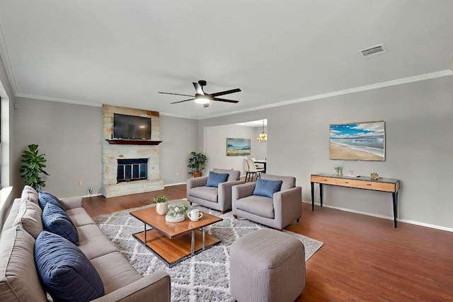2617 Chowan Cv, Round Rock, TX 78681 - living room with ceiling fan, wood finished floors, crown molding, and a fireplace