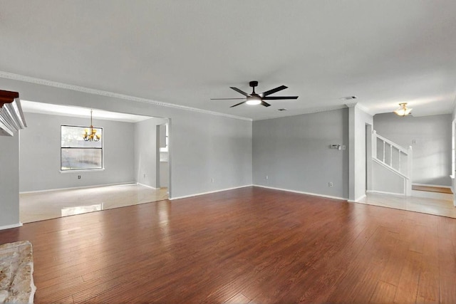 2617 Chowan Cv, Round Rock, TX 78681 - unfurnished living room featuring a chandelier, wood finished floors, crown molding, ceiling fan, and stairway