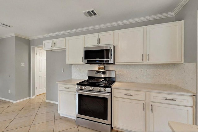 2617 Chowan Cv, Round Rock, TX 78681 - kitchen with appliances with stainless steel finishes, backsplash, light countertops, crown molding, and light tile patterned floors